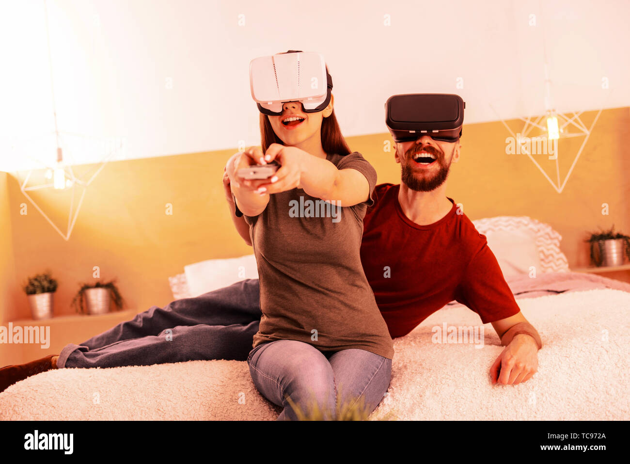 Nice couple playing different virtul games while being at home Stock Photo