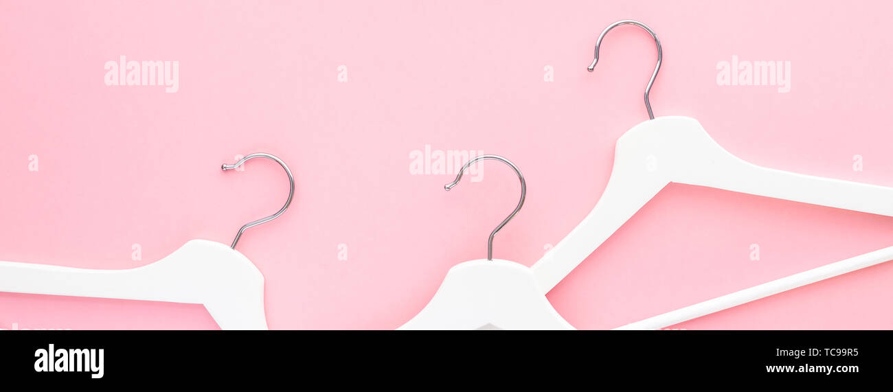 Creative top view flat lay white wooden hangers pastel millennial pink ...