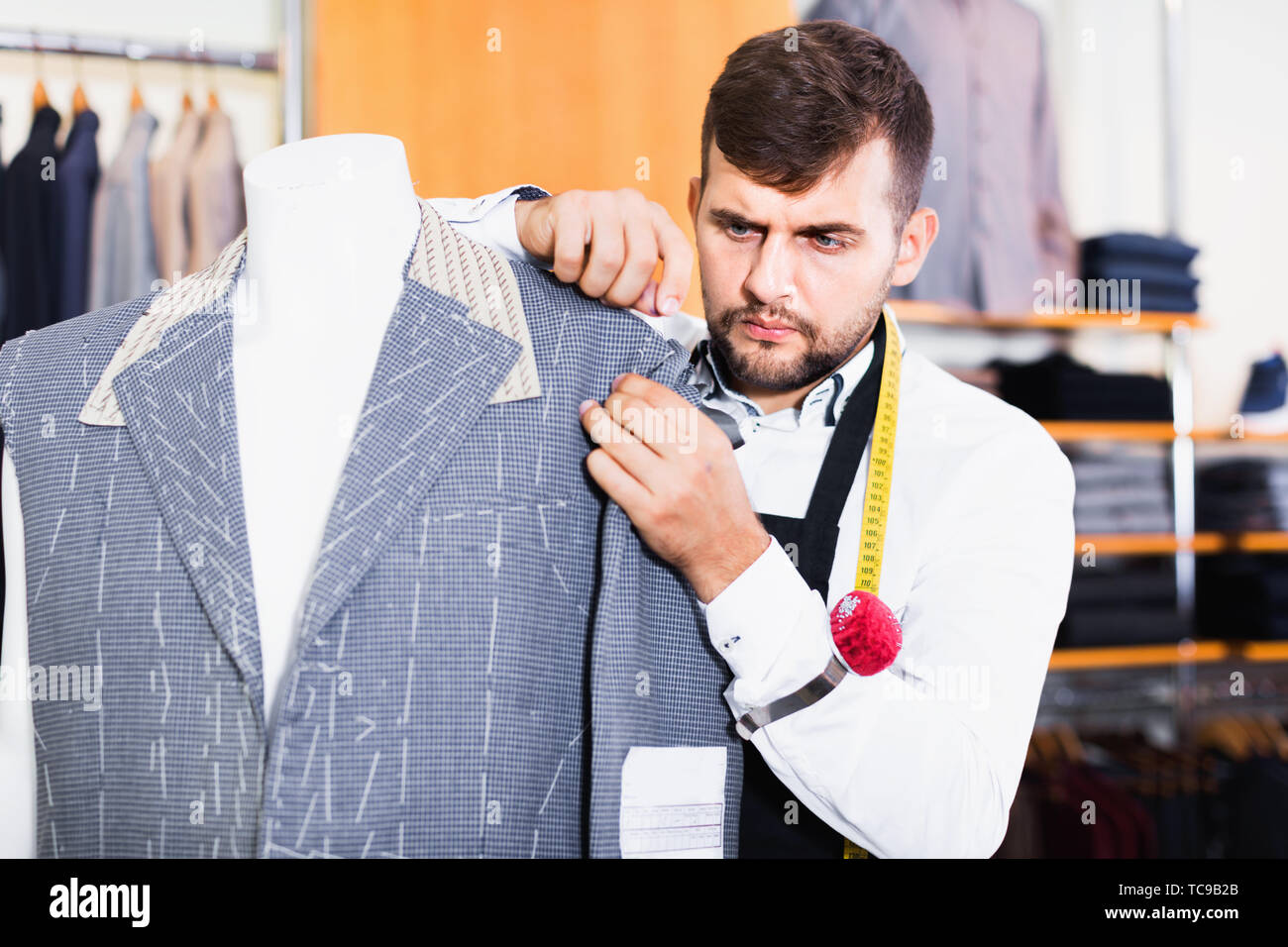 Happy positive smiling handsome male tailor working in atelier Stock ...