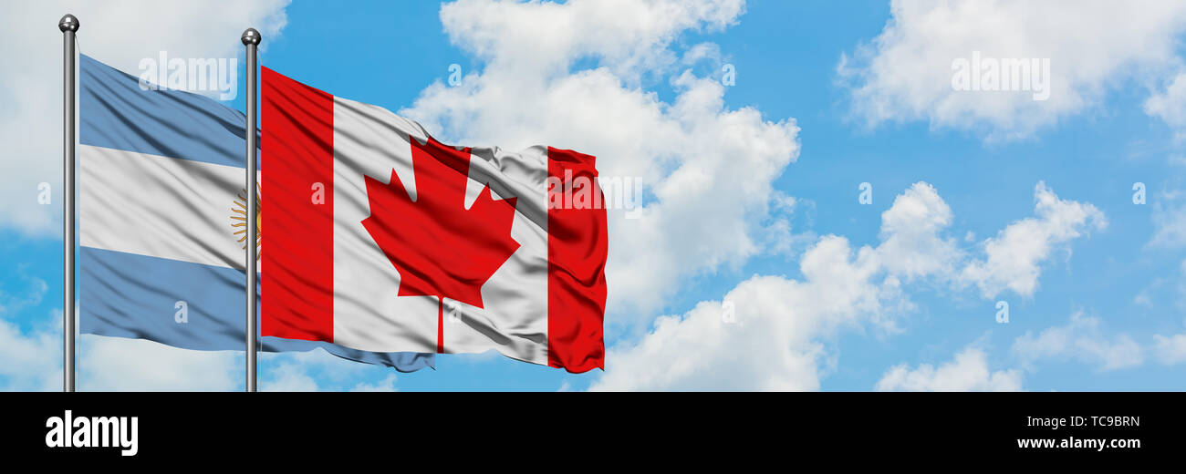 Argentina and Canada flag waving in the wind against white cloudy blue ...
