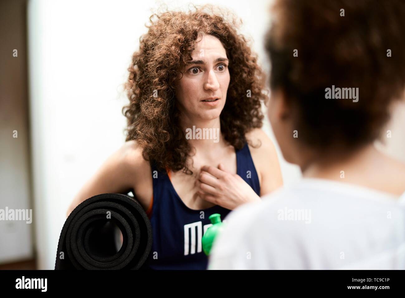 compassionate woman listening to story of friend in fitness studio Stock Photo