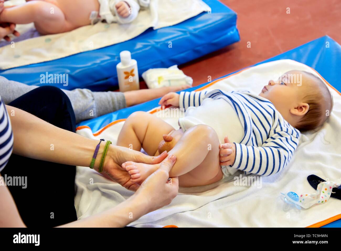 Matron instructing mothers in massage to babies, Health Center, Zarautz, Gipuzkoa, Basque Country, Spain Stock Photo