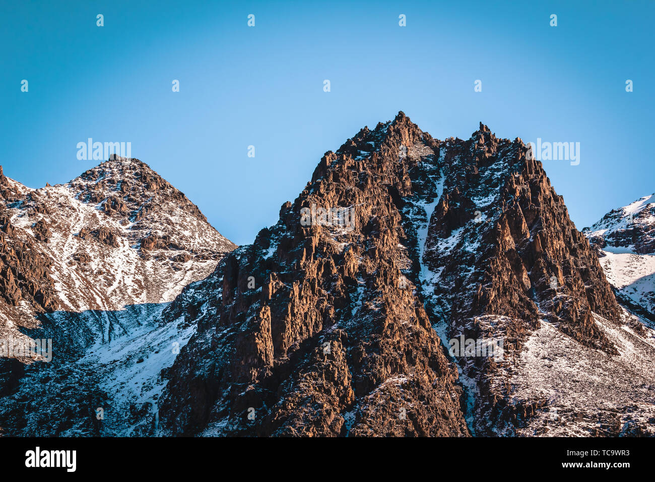 Mountain ridge covered with snow, winter in mountain valley Stock Photo ...