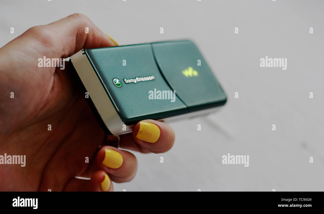 Woman is holding a green Sony Ericsson W580i Walkman released August 2007, Wales, United Kingdom. Mobile phone with buttons from Virgin Mobile contrac Stock Photo