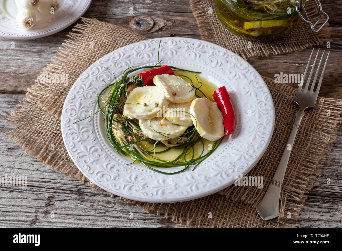 Goat cheese marinated in olive oil with wild crow garlic, hot peppers