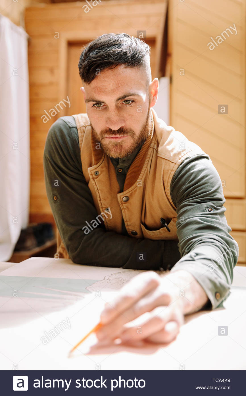 Focused male artist drawing Stock Photo Alamy
