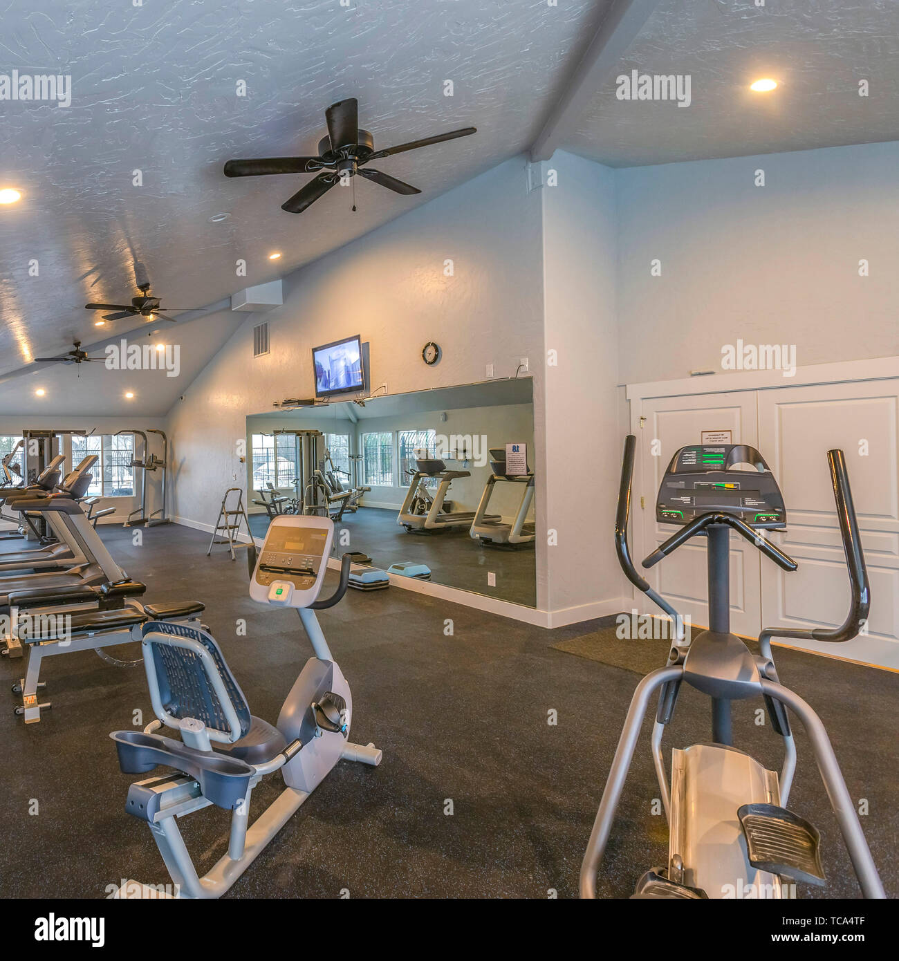 Square Interior of a spacious fitness gym with various exercise equipment Stock Photo