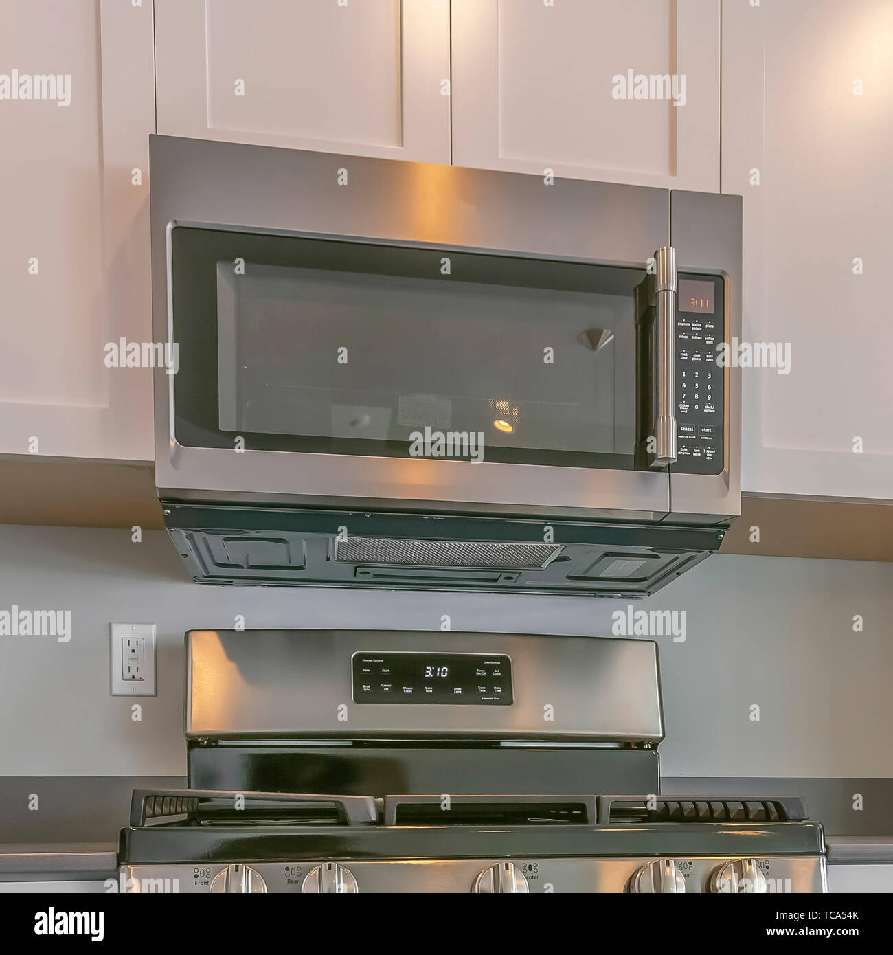 Frame Square Range And Wall Mounted Microwave Inside The Modern Kitchen Of A New House Stock Photo Alamy