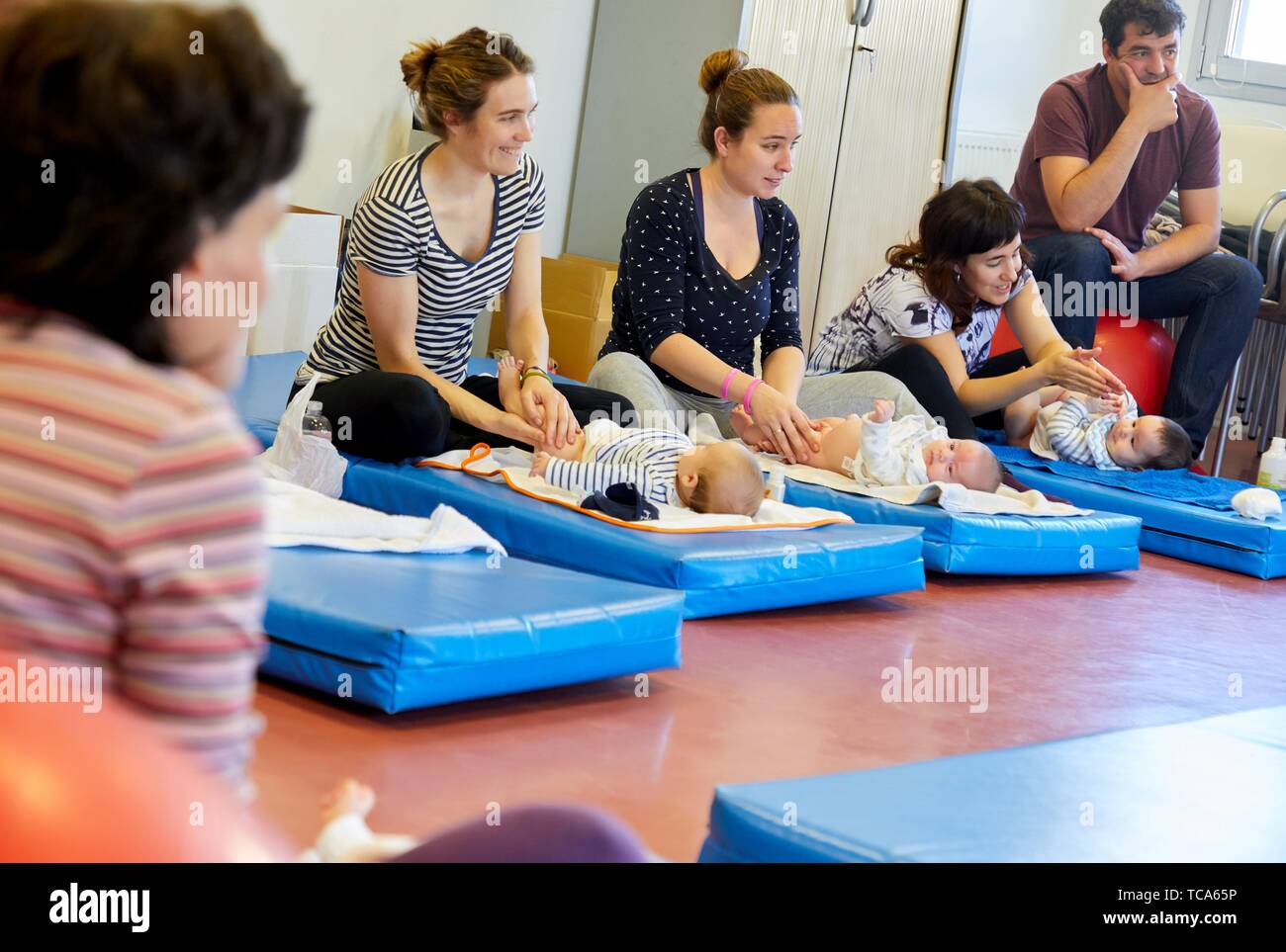Matron instructing mothers in massage to babies, Health Center, Zarautz, Gipuzkoa, Basque Country, Spain Stock Photo