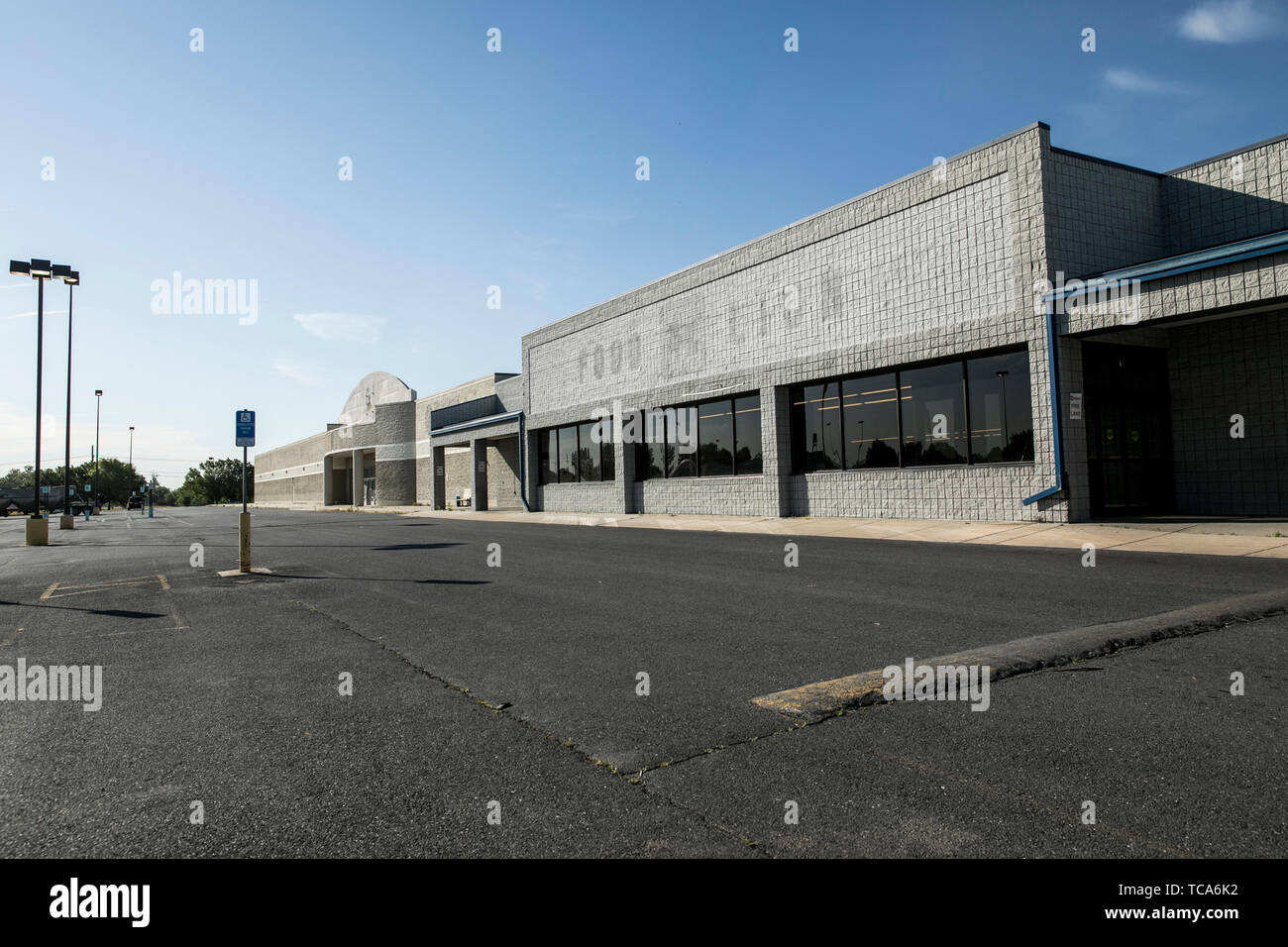The outline of a logo sign outside of an abandoned Food Lion retail grocery store location in Martinsburg, West Virginia on June 4, 2019. Stock Photo