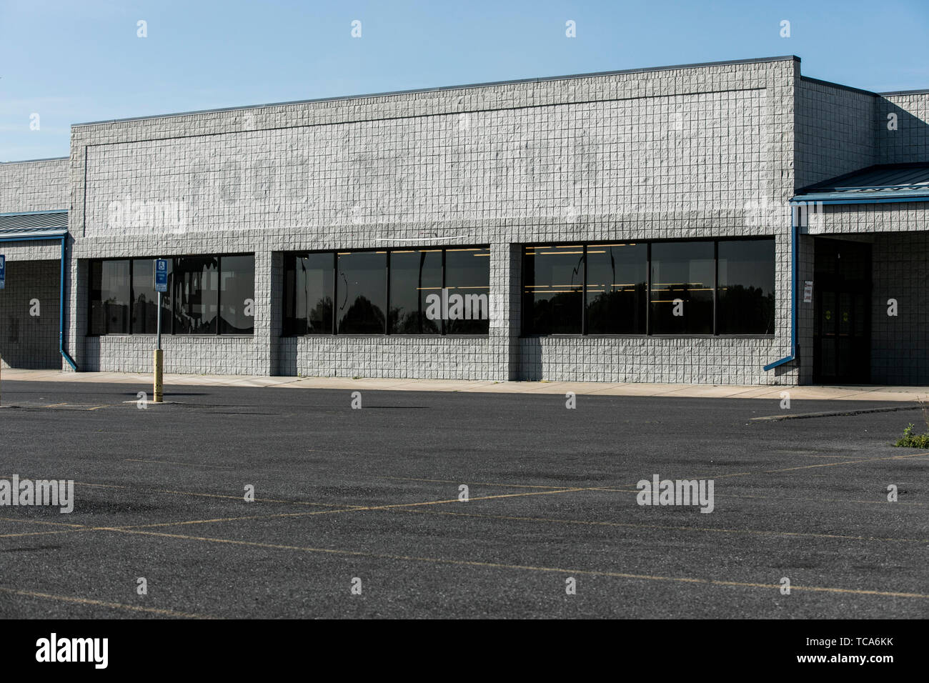 The outline of a logo sign outside of an abandoned Food Lion retail grocery store location in Martinsburg, West Virginia on June 4, 2019. Stock Photo