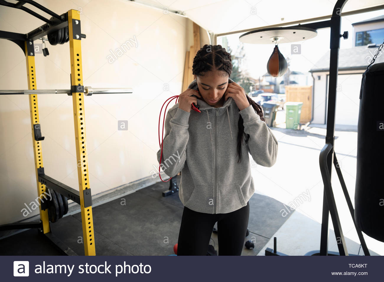 Teenage girl working out in garage Stock Photo