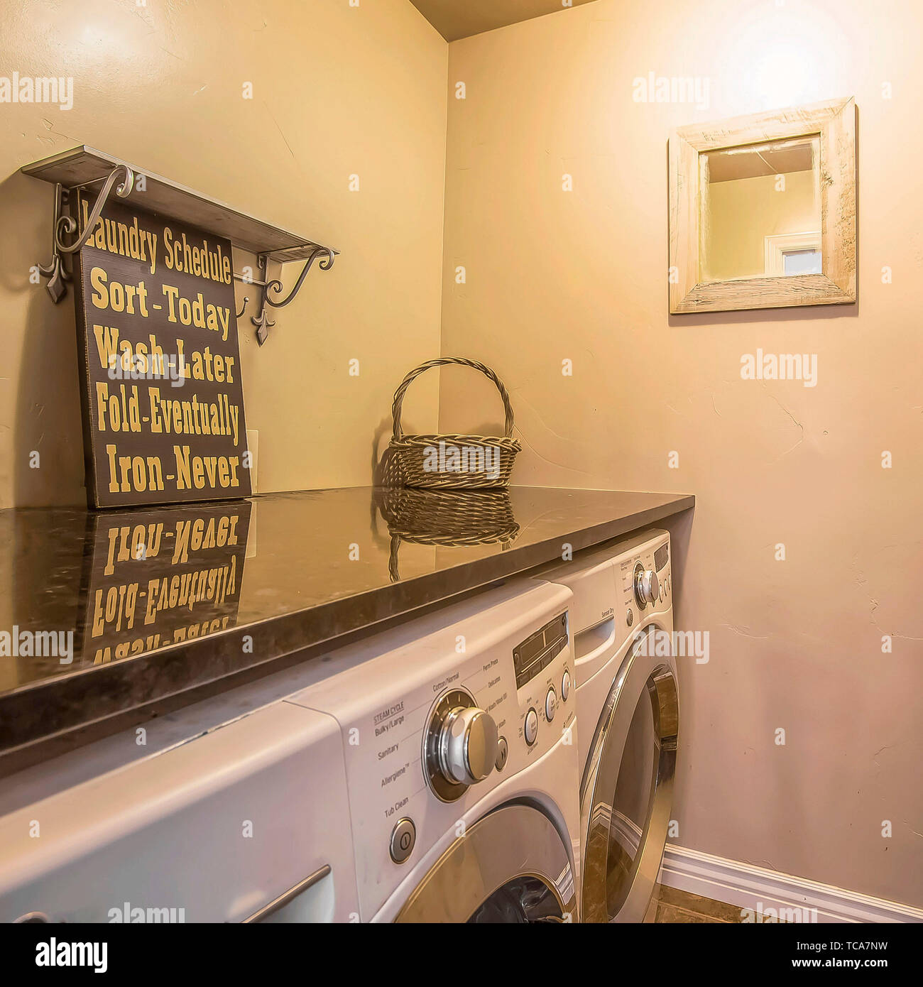 Frame Square Washing machine and dryer inside the small laundry room of a  home Stock Photo - Alamy