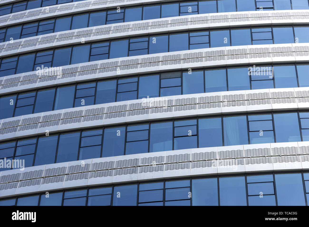 Modern office building with glass wall Stock Photo - Alamy