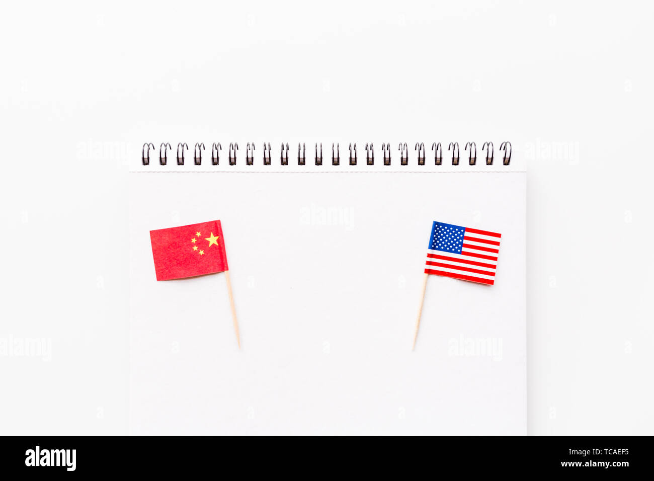 Creative top view flat lay of China and USA flag, mockup and copy space on white background in minimal style. Concept of trade war between USA and Stock Photo