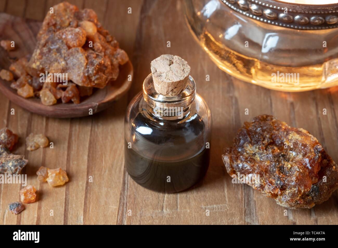 A bottle of myrrh essential oil with myrrh resin on a dark background Stock  Photo - Alamy