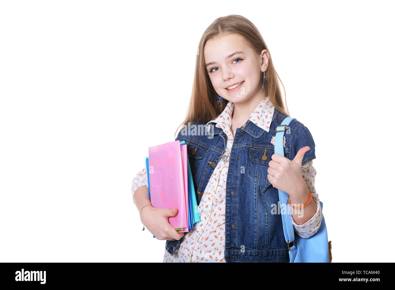 Happy schoolgirl posing with books on white background Stock Photo - Alamy