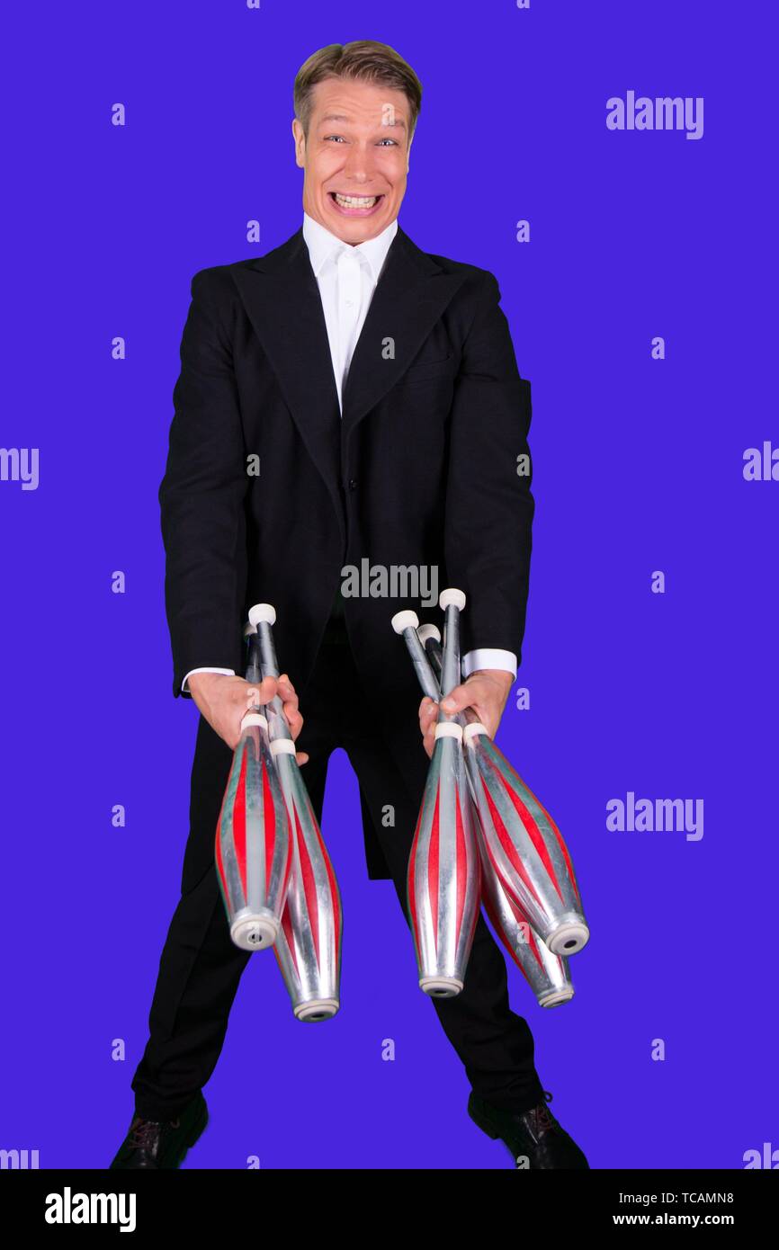 Elegant and happy juggler with five juggling clubs Stock Photo Alamy