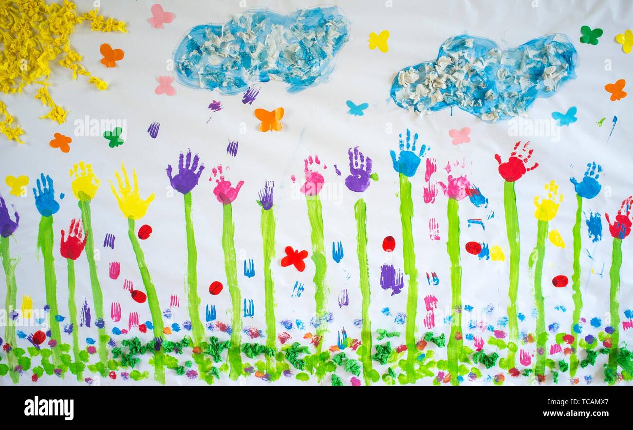 Spring mural draw over craft paper painted with hands prints. Made by nursery children. Stock Photo