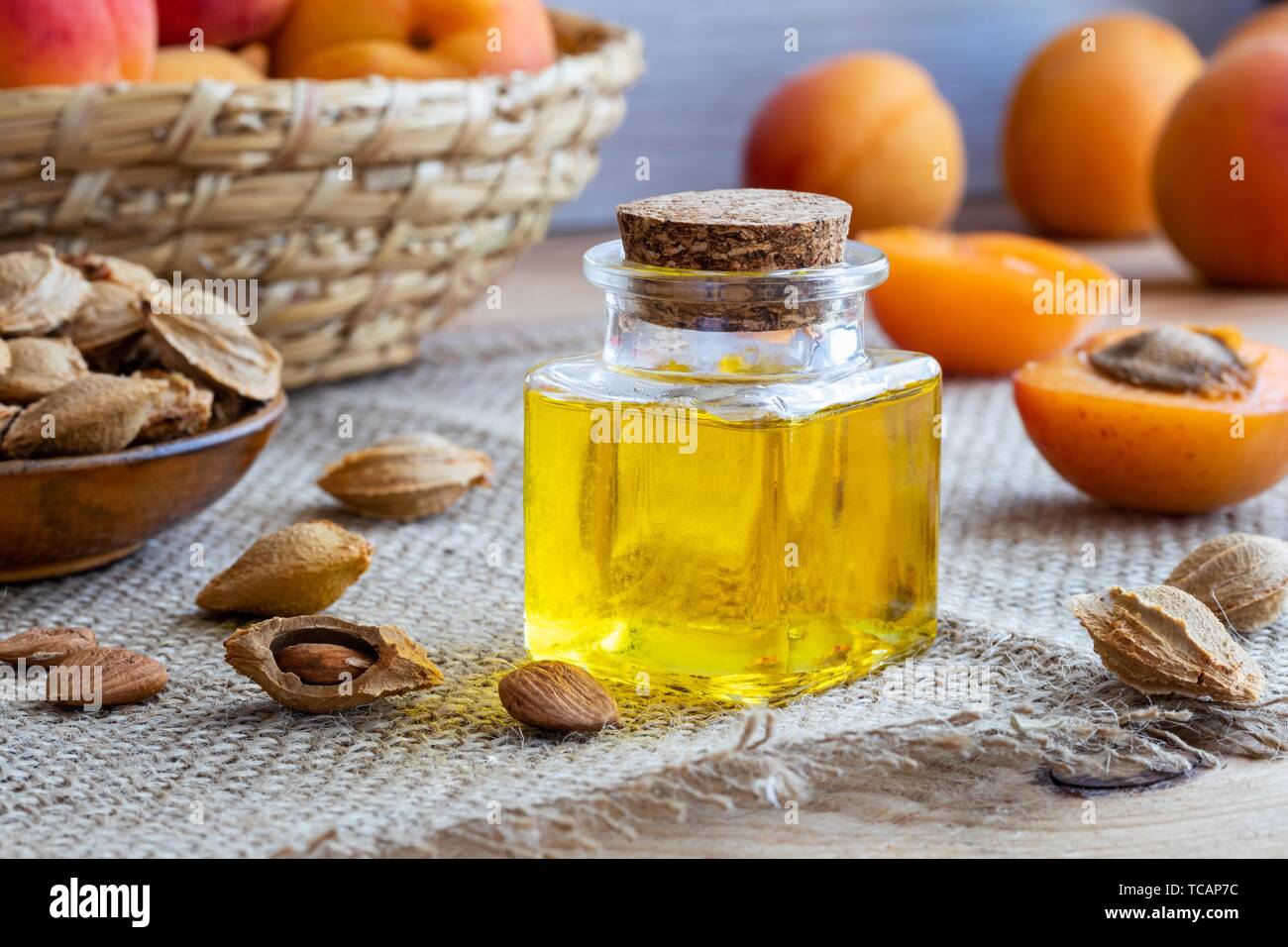 A bottle of apricot kernel oil with fresh ripe fruit. Stock Photo