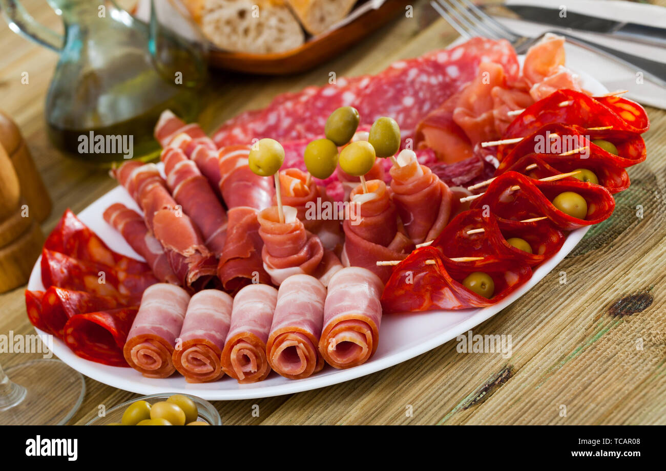 Traditional Spanish meat platter sliced dry cured jamon bacon and Traditional Spanish meat platter sliced dry cured jamon bacon and