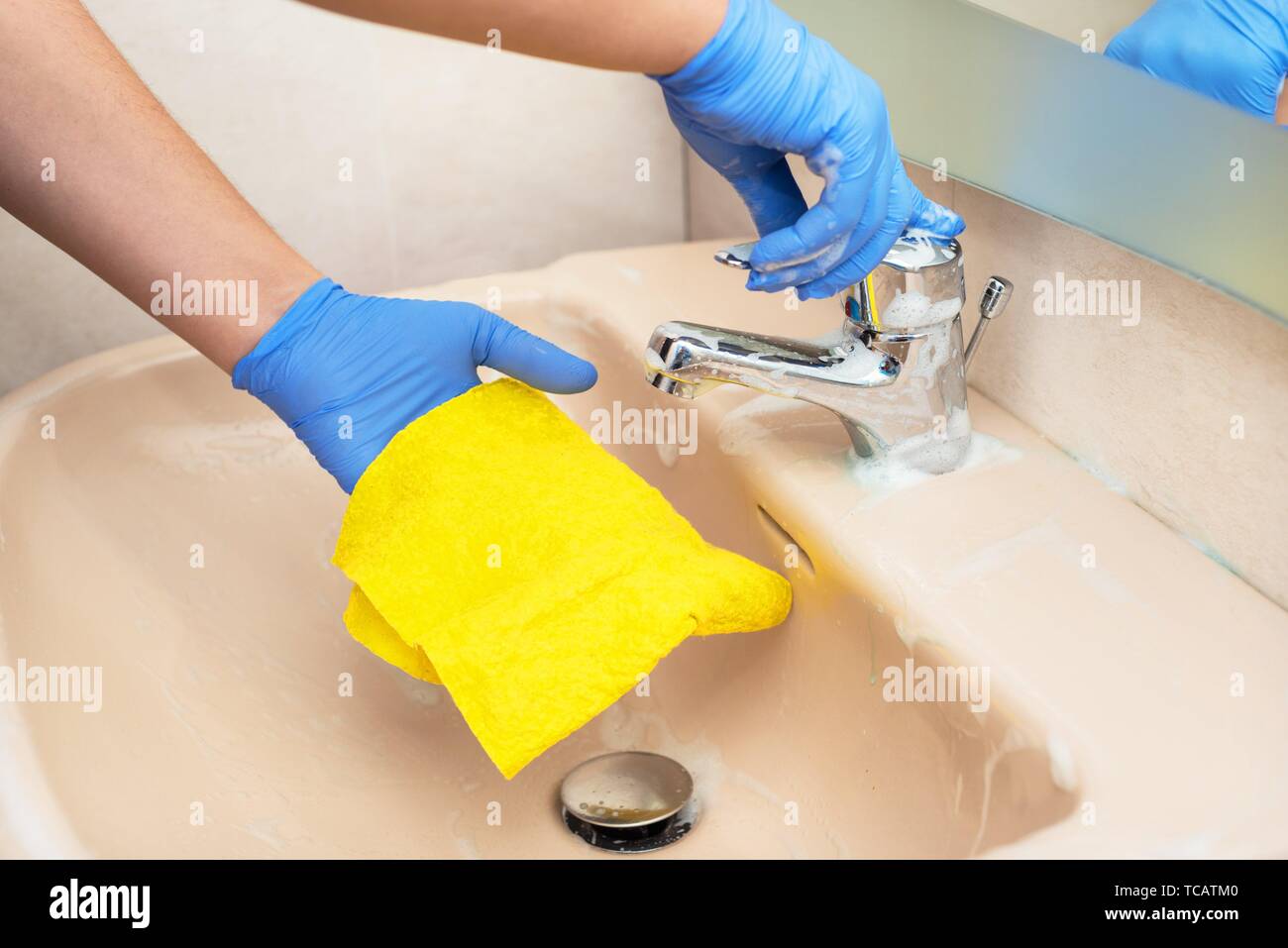 Man cleaning the bathroom sink. Man doing chores Stock Photo Alamy