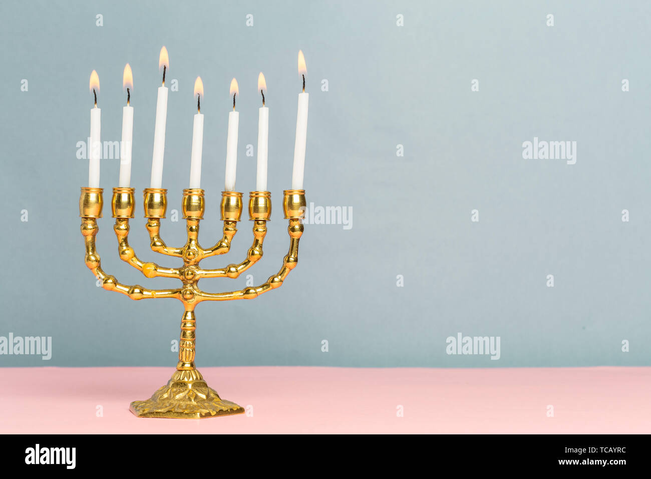 Bronze Hanukkah menorah with burning candles Stock Photo Alamy