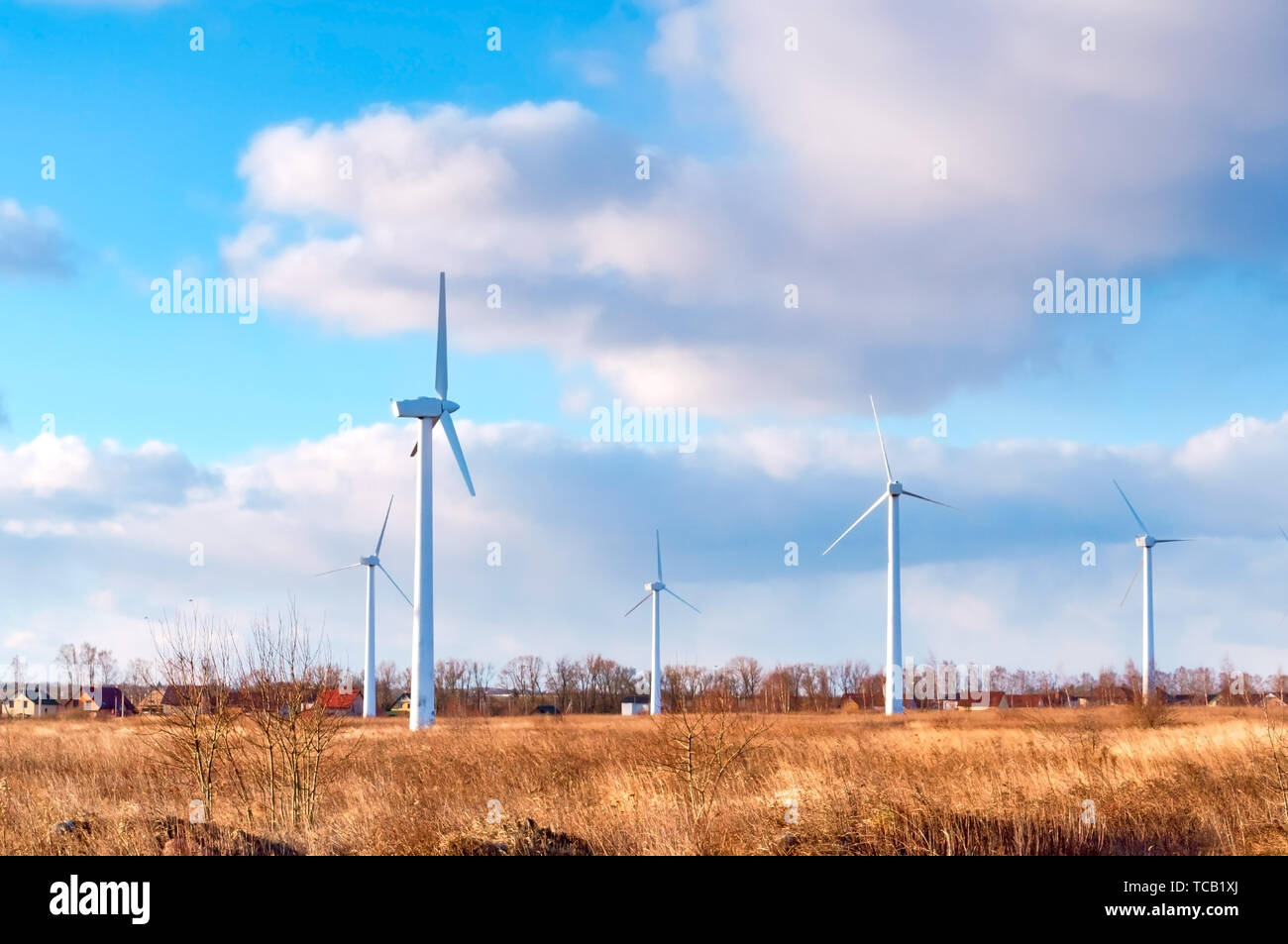 wind farm in the field, freshly plowed field, agricultural land and wind turbines Stock Photo