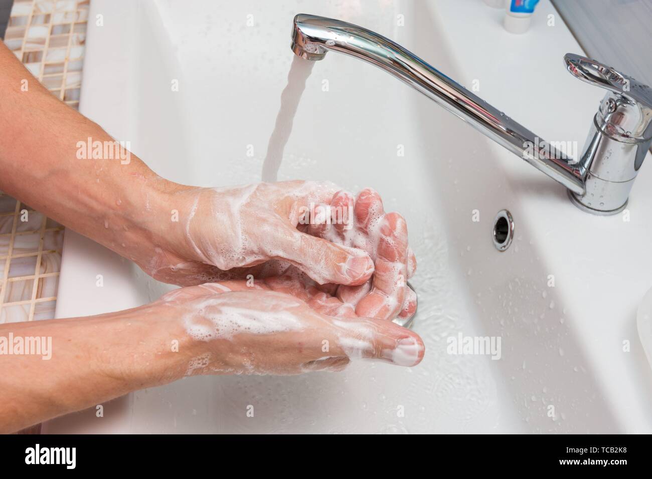 Washing hands with soap in the sink Stock Photo Alamy