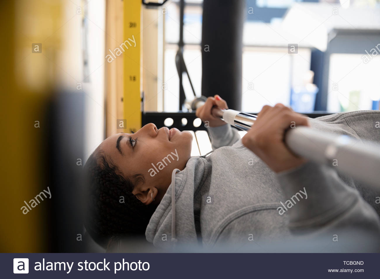 Focused teenage girl lifting weights Stock Photo Alamy
