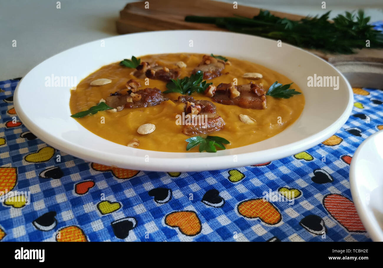 Pumpkin soup with bacon fried with nuts. Stock Photo