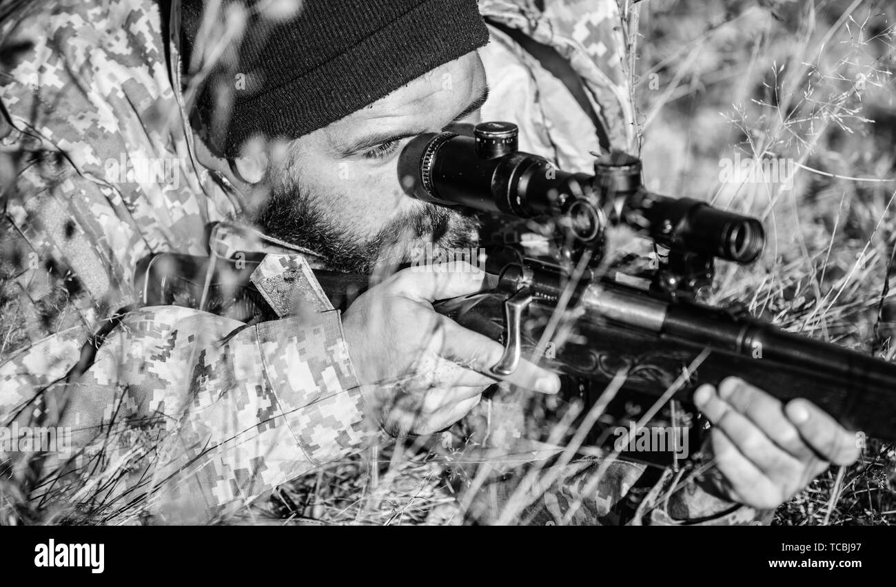 Army forces. Camouflage. Bearded man hunter. Hunting skills and weapon equipment. How turn hunting into hobby. Military uniform fashion. Man hunter with rifle gun. Military Operation in the Desert. Stock Photo