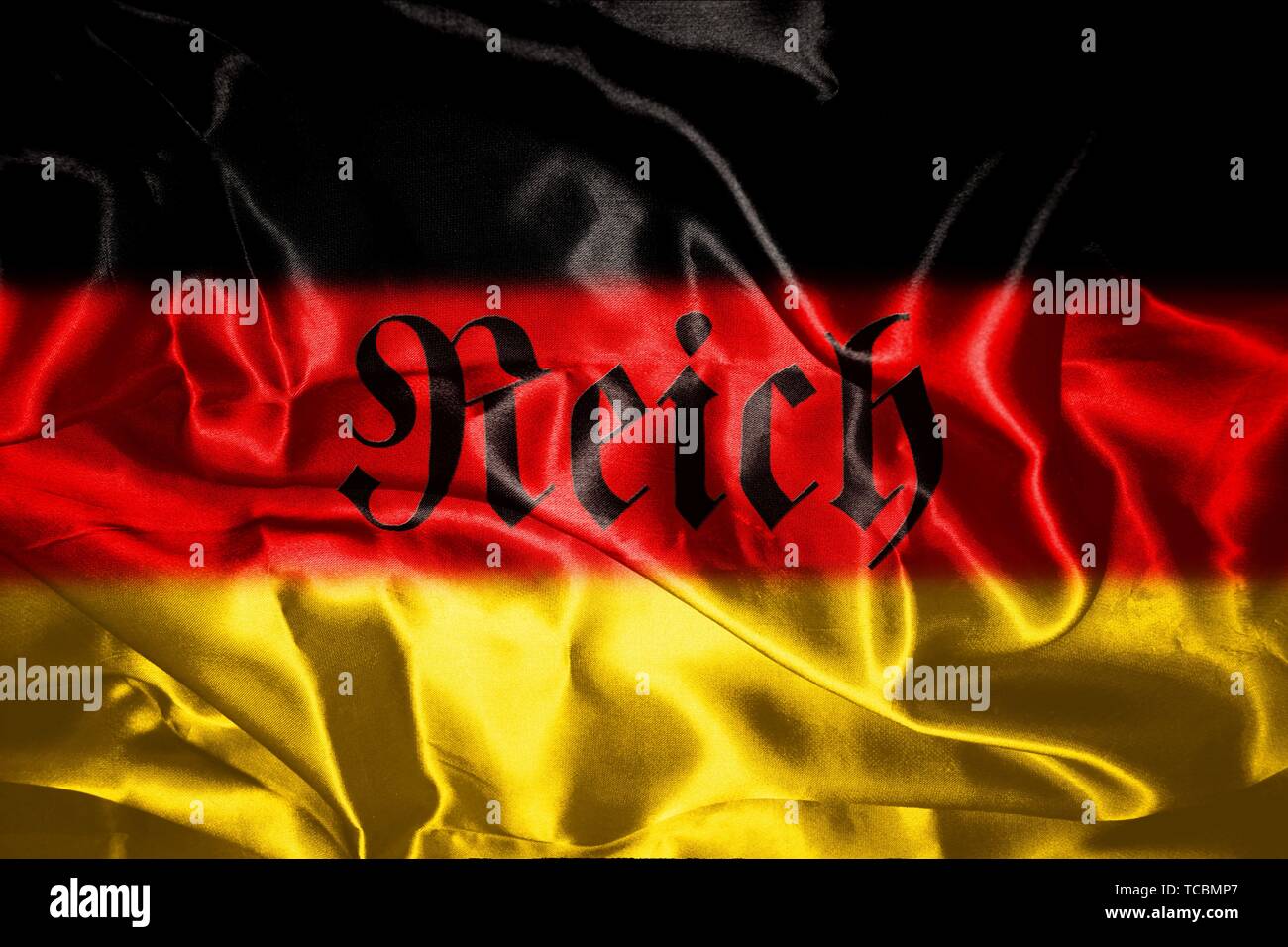 German flag blowing in the wind With Reich Written On It Which Means Realm. Stock Photo