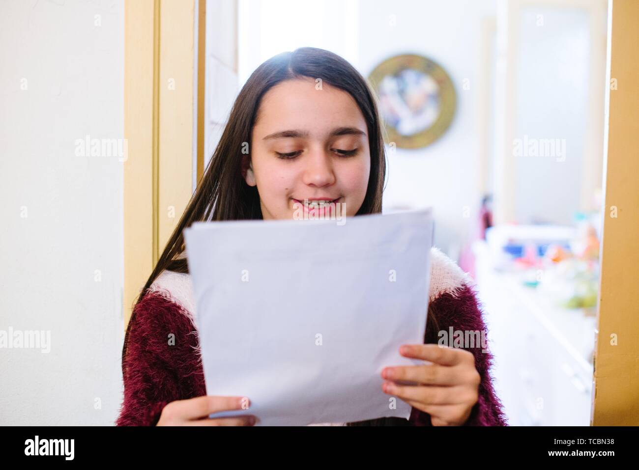 Girl reading paper school hires stock photography and images Alamy