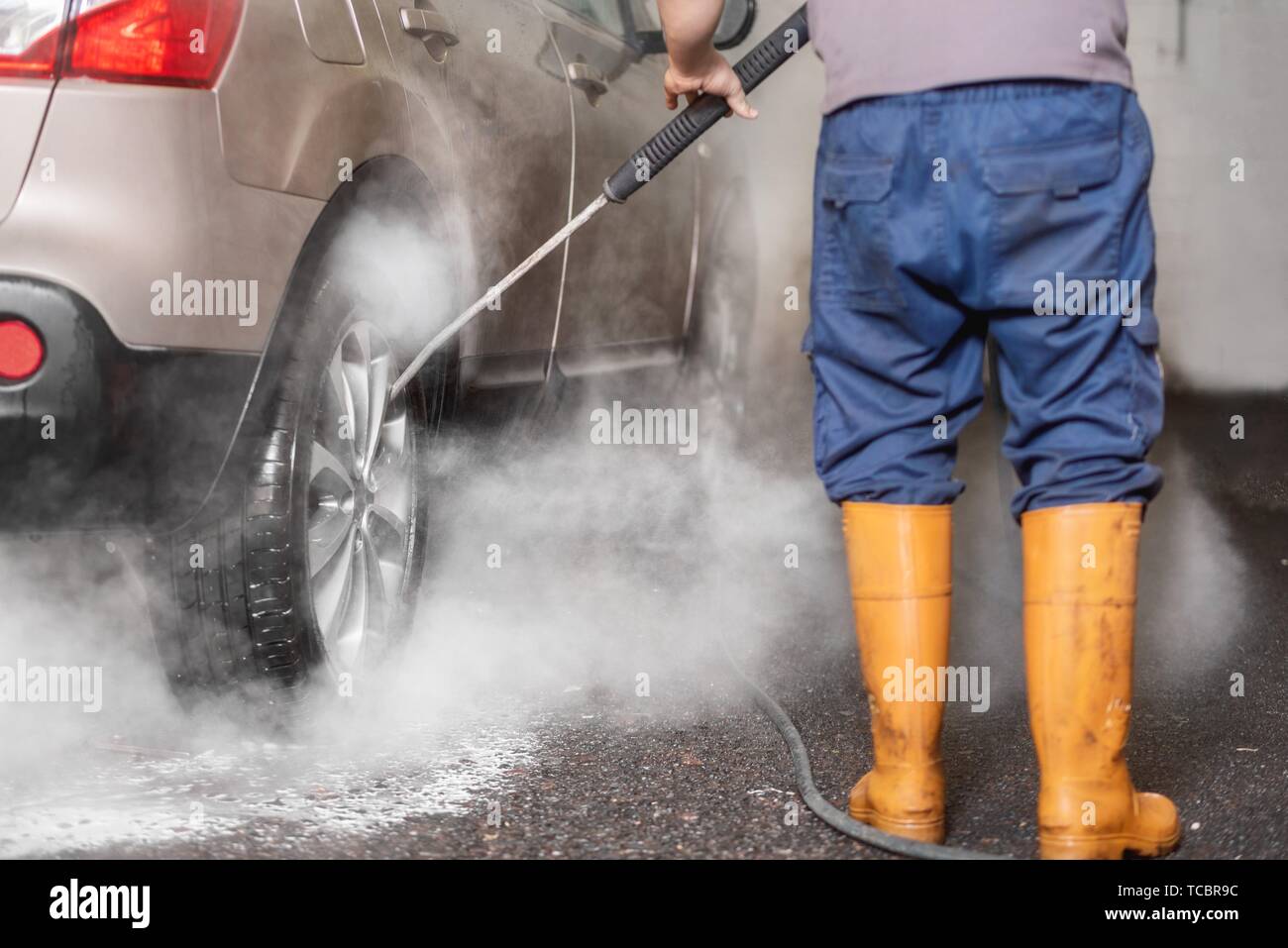 Manual car wash with pressurized water in car wash outside Stock Photo