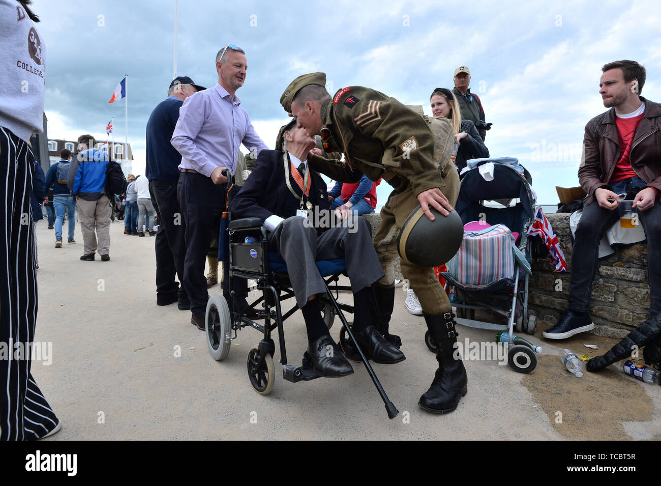 A French actor in military dress says goodbye to one of the war veterans after a ceremony in Arromanches in Normandy, northern France, during commemorations for the 75th anniversary of the D-Day landings. Stock Photo