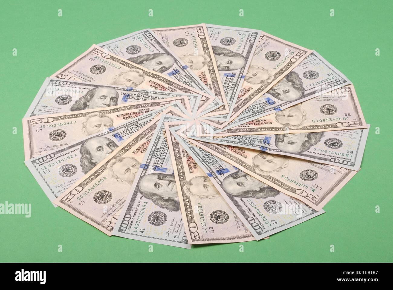 Money in the shape of a circle isolated on green background Stock Photo