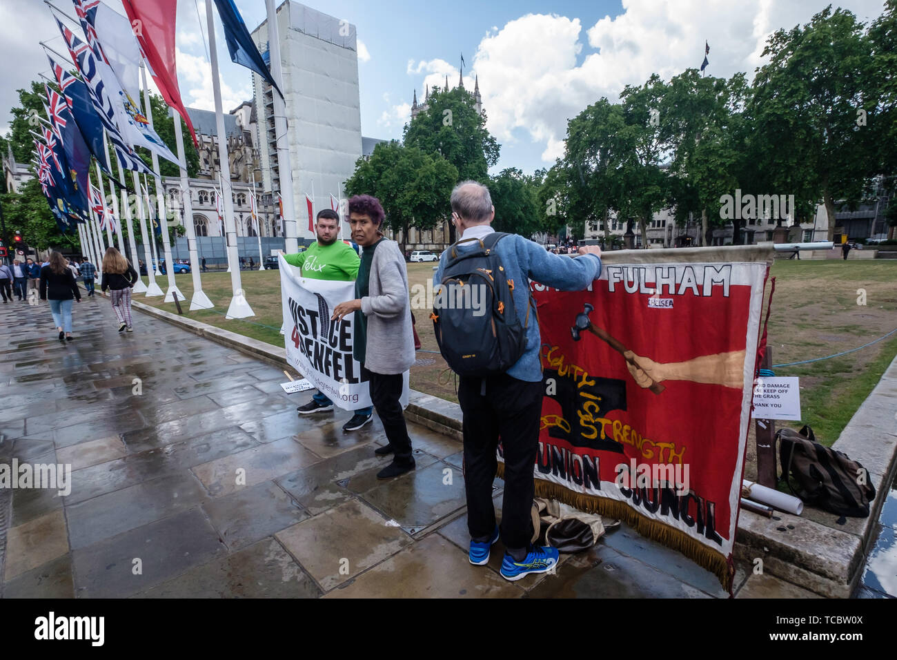 London, UK. 6th June 2019. Just before the second anniversary of the disastrous fire, a small group of activists including Moyra Samuels with Justice4Grenfell and Hammersith & Fulham TU Council banners at MP Emma Dent Coad asked questions. Promises made by Theresa May and Kensington & Chelsea council to the survivors have not been kept and no arrests have been made over the corruption, criminal negligence and disregard for safety that led to 72 deaths. They call for Government action to rehouse survivors, clear toxic waste, make all similar blocks safe and ensure justice. Peter Marshall/Alamy  Stock Photo