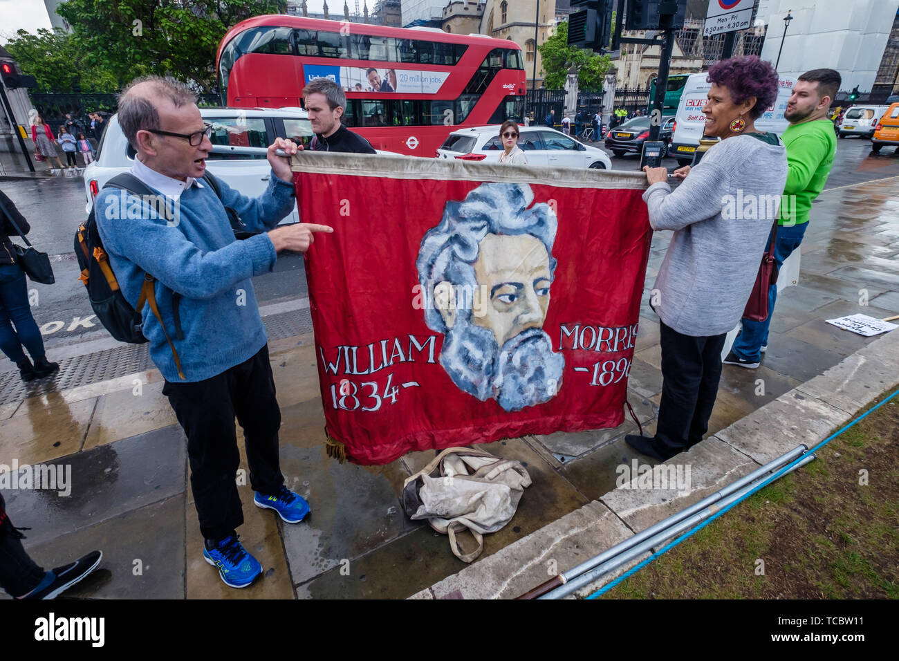 London, UK. 6th June 2019. Just before the second anniversary of the disastrous fire, a small group of activists including Moyra Samuels holds the Hammersith & Fulham TU Council banner at MP Emma Dent Coad asked questions. Promises made by Theresa May and Kensington & Chelsea council to the survivors have not been kept and no arrests have been made over the corruption, criminal negligence and disregard for safety that led to 72 deaths. They call for Government action to rehouse survivors, clear toxic waste, make all similar blocks safe and ensure justice. Peter Marshall/Alamy Live News Stock Photo