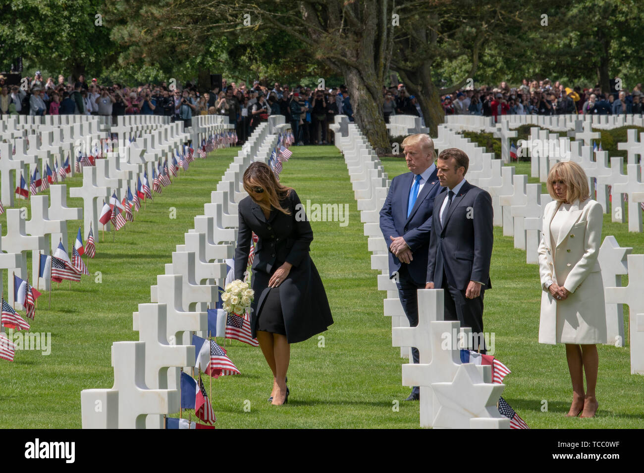 U.S. First Lady Melania Trump places flowers at the grave of an American  service member buried at the Normandy American Cemetery as President Donald  Trump/ French President Emmanuel Macron and his wife