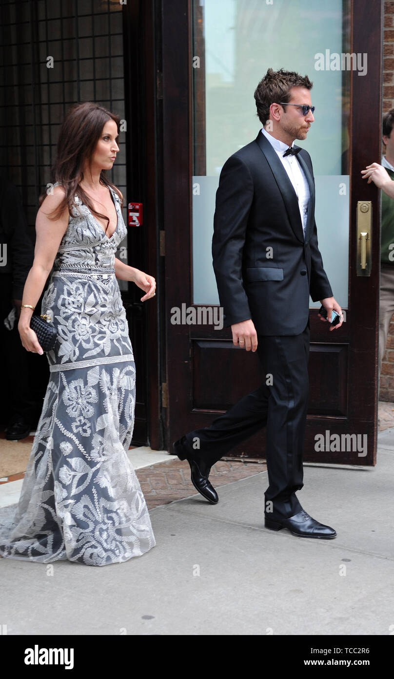 NEW YORK, NY - MAY 02: Bradley Cooper and Amanda Anka (daughter of singer Paul Anka and wife of Jason Bateman, who was present but not pictured) exit their downtown hotel en route to the Met Costume Gala 2011.  on May 2, 2011 in New York City  People:  Bradley Cooper Amanda Anka Stock Photo