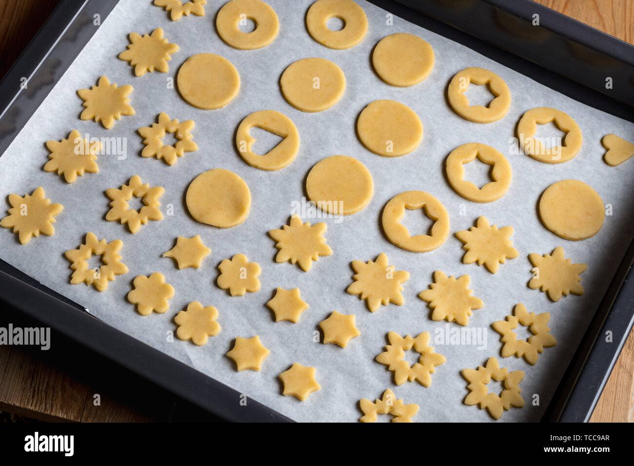 Preparation of traditional Linzer Christmas cookies cut out shapes on