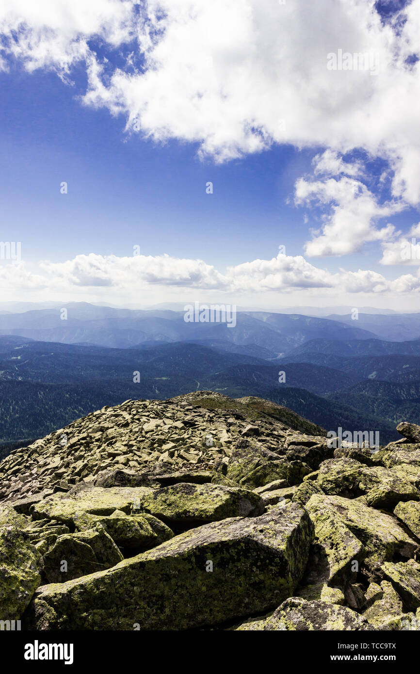 Rocks under blue sky with clouds. View of mountain valley. Tourism ...