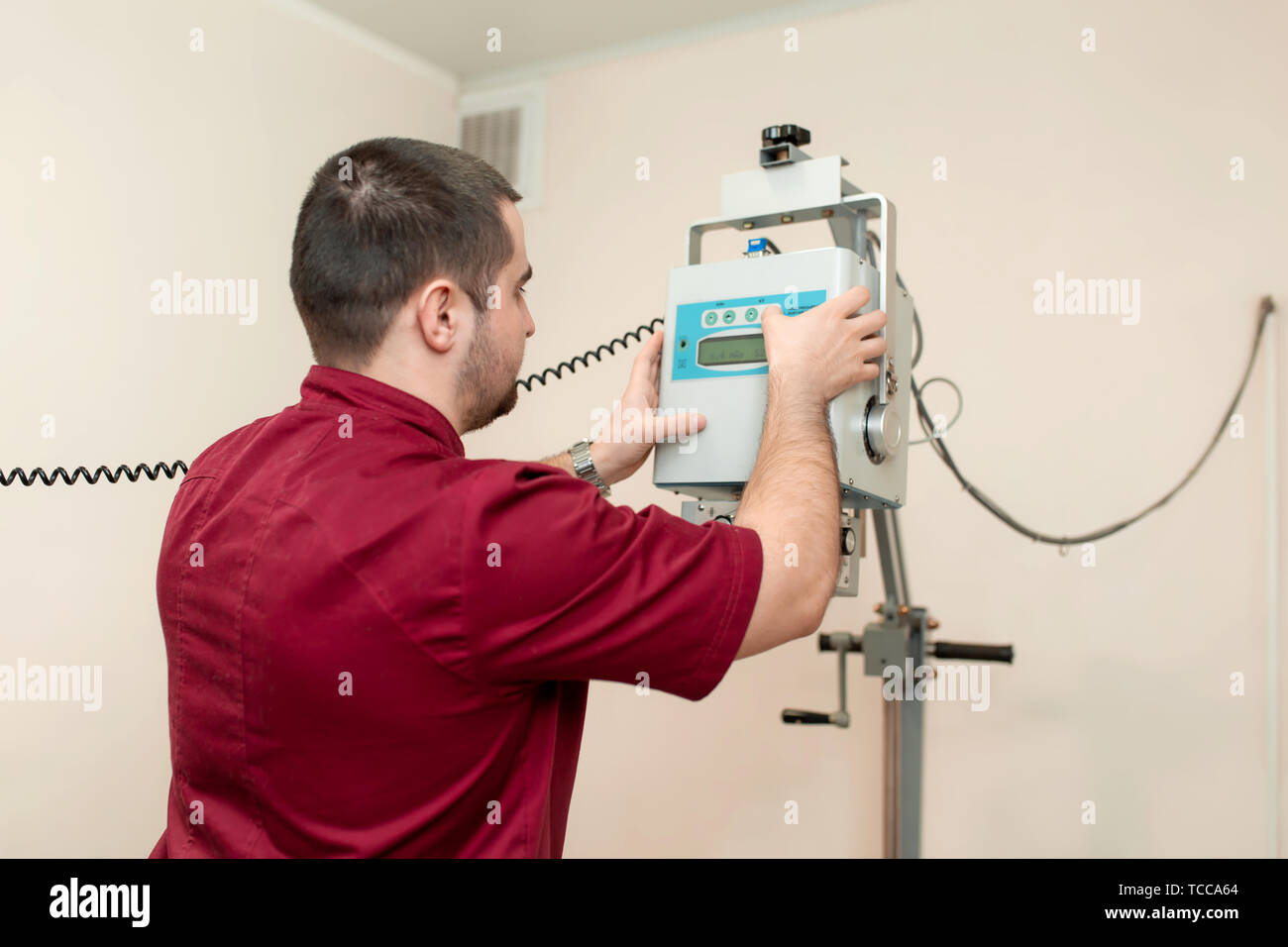 Professional veterinarian doctor adjust X-ray machine in veterinary hospital before scanning procedure. Stock Photo