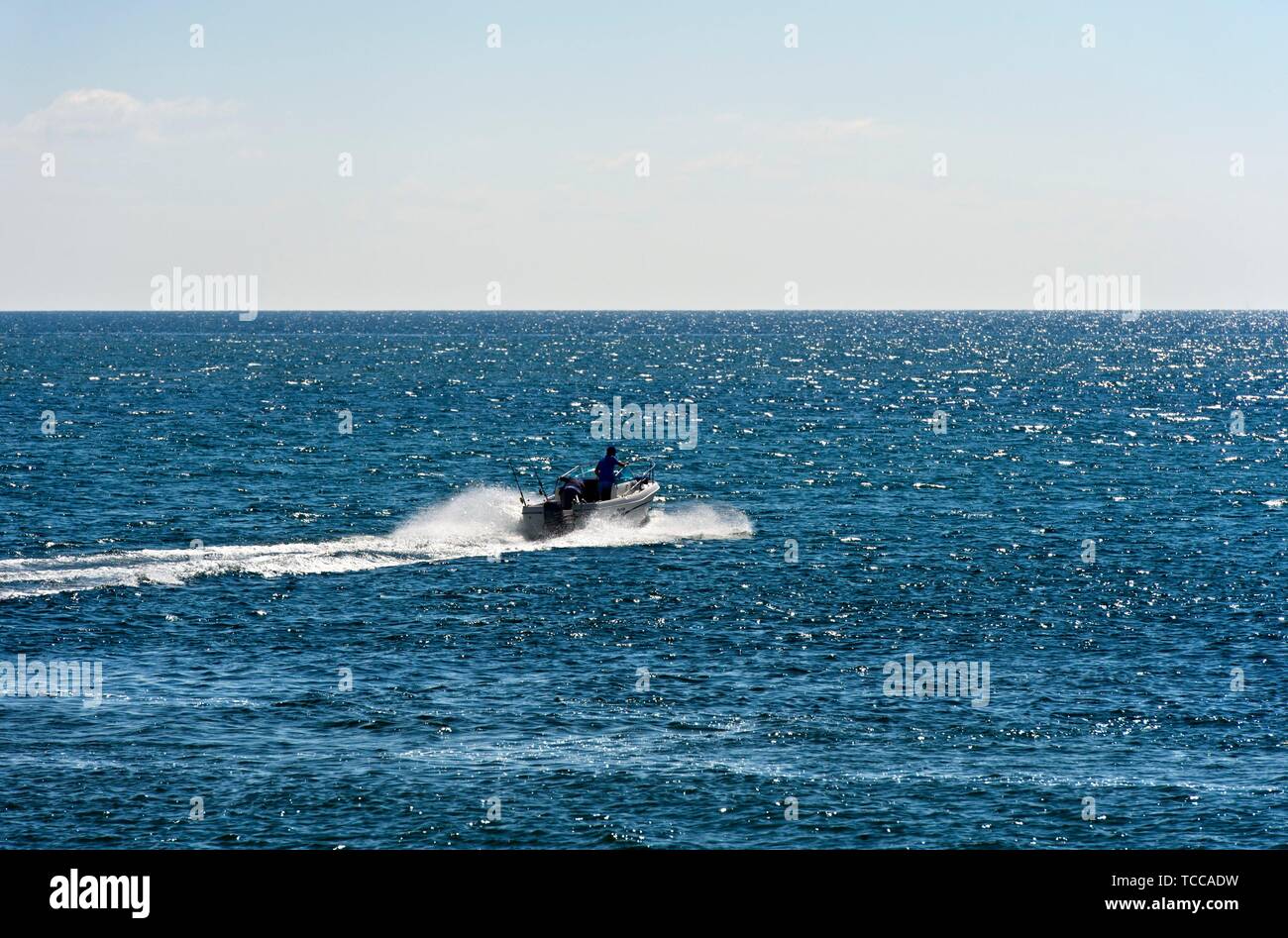 Motorboat on the open sea, near Tavira, Algarve, Portugal. Stock Photo