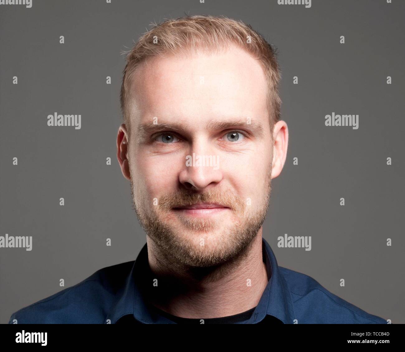 Man in blue shirt hi-res stock photography and images - Alamy