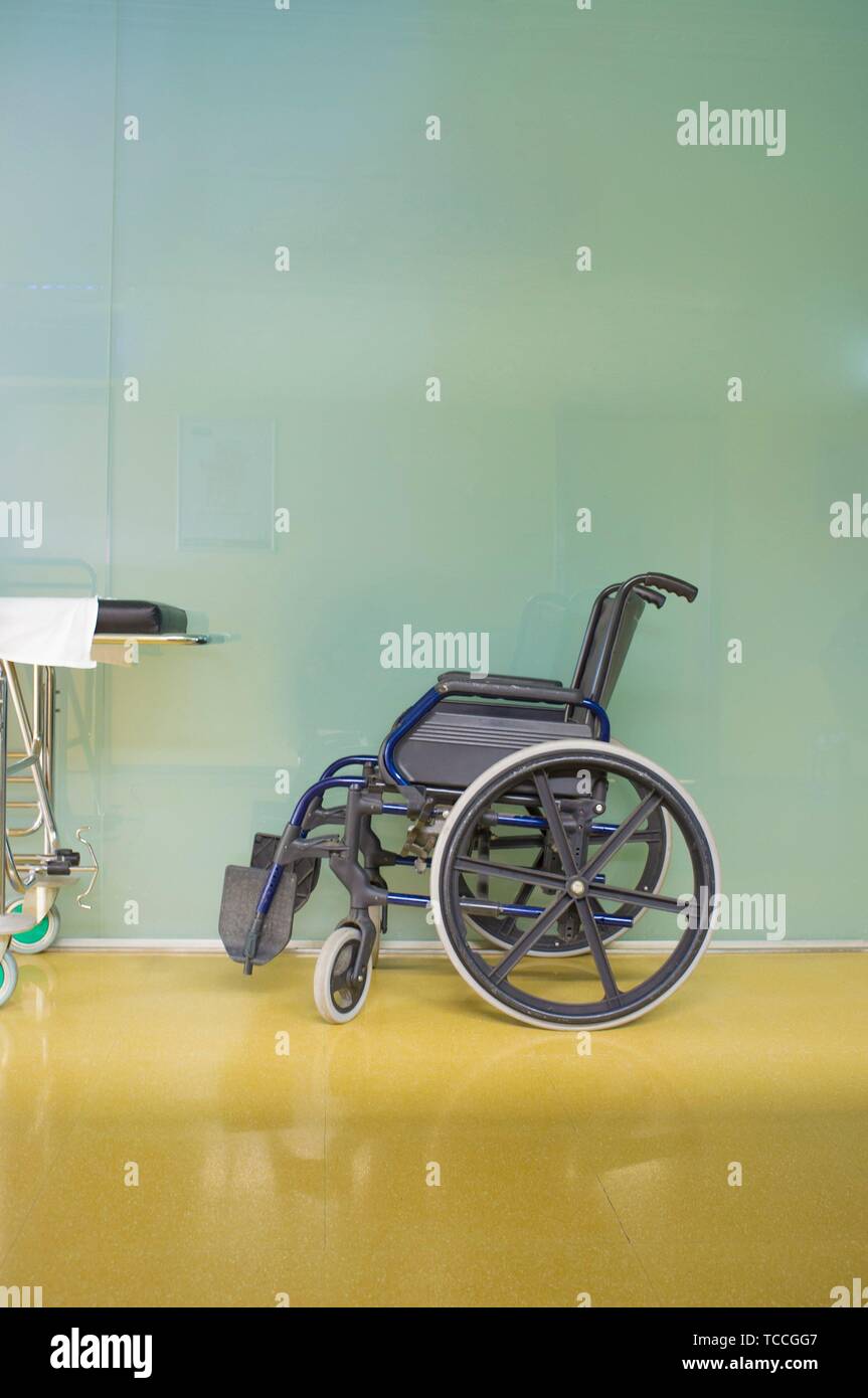 Interior of healthcare center hallway. Modern and gleaming environment with wheelchair. Stock Photo