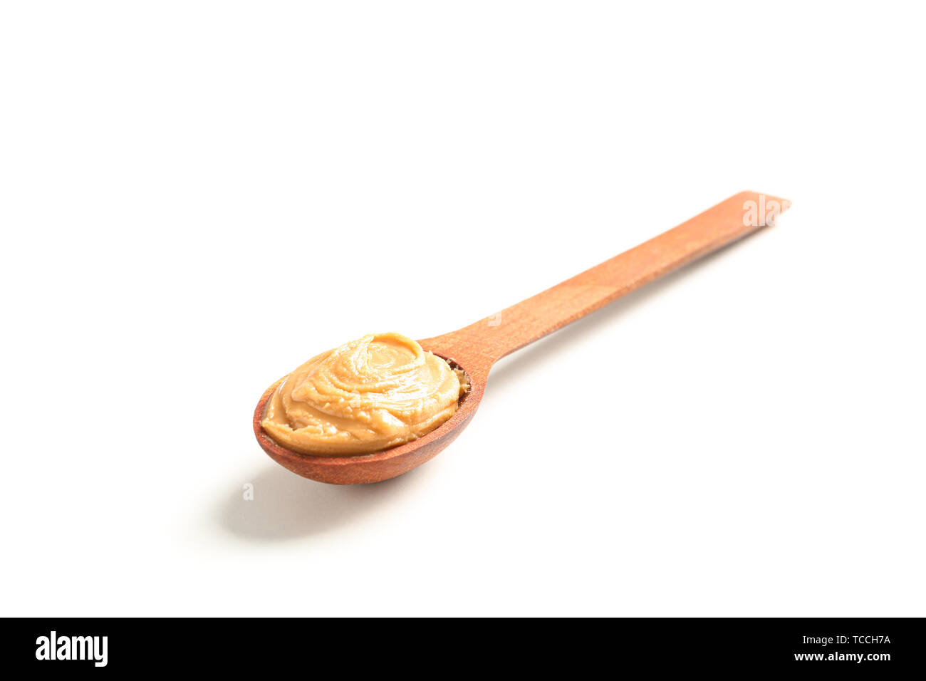 Creamy peanut butter in spoon isolated on white background, closeup. A  traditional product of American cuisine Stock Photo - Alamy