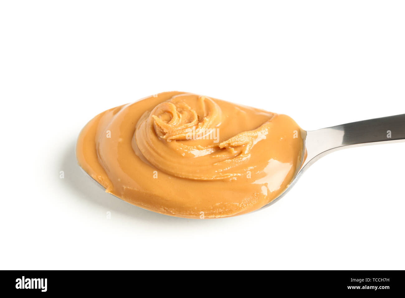 Creamy peanut butter in spoon isolated on white background, closeup. A  traditional product of American cuisine Stock Photo - Alamy