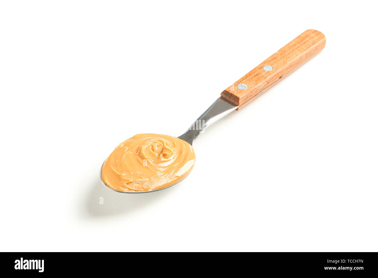 Wooden spoon of peanut butter Stock Photo by Alex9500